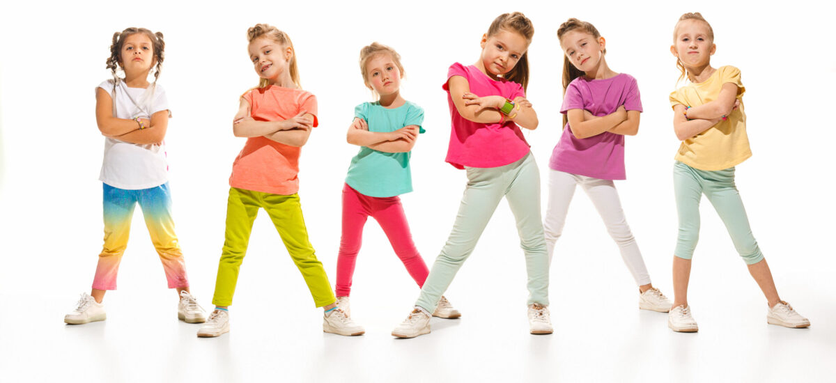 The kids dance school, ballet, hiphop, street, funky and modern dancers on white studio background. Girl is showing aerobic and dance element. Teen in hip hop style
